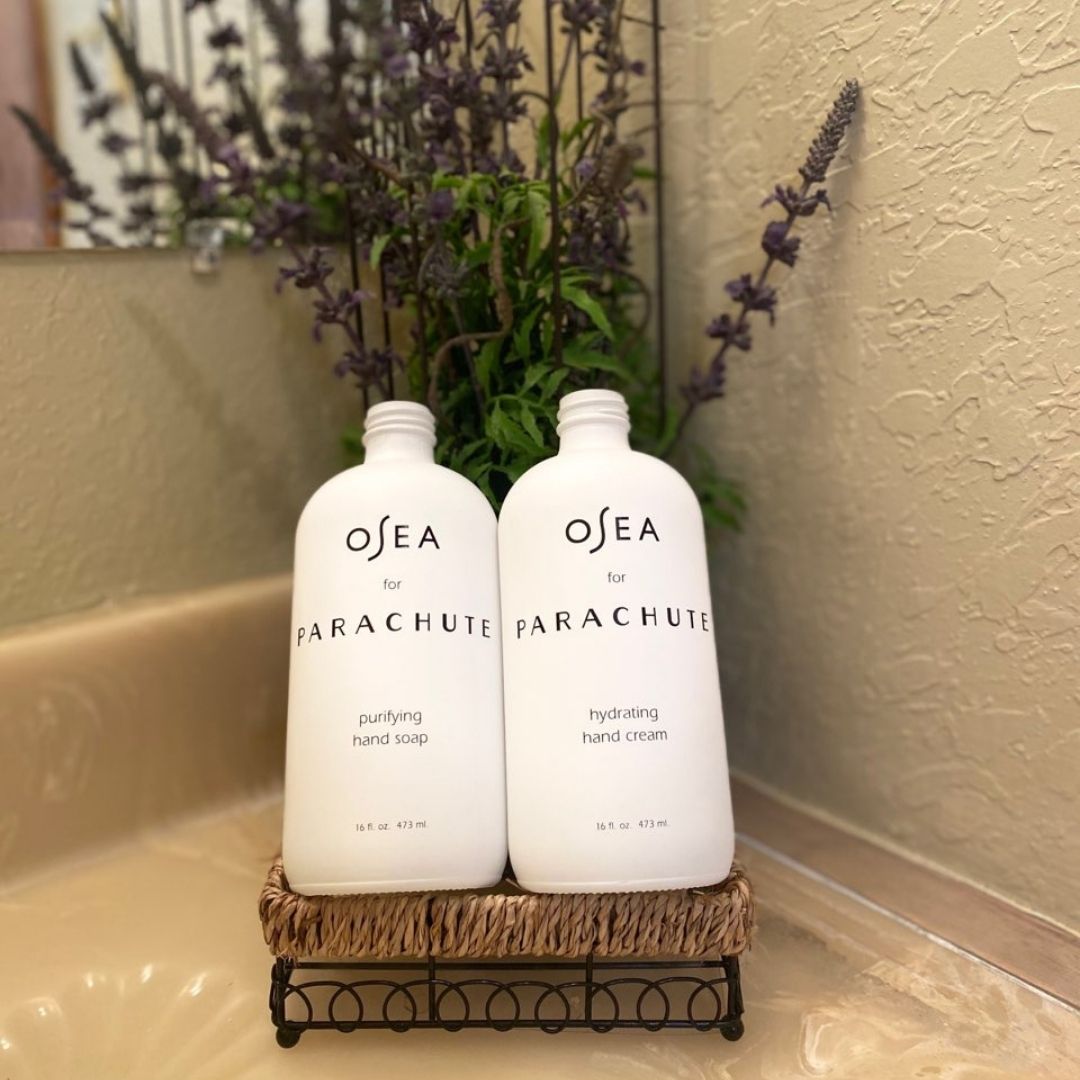 two beauty product bottles displayed in a bathroom